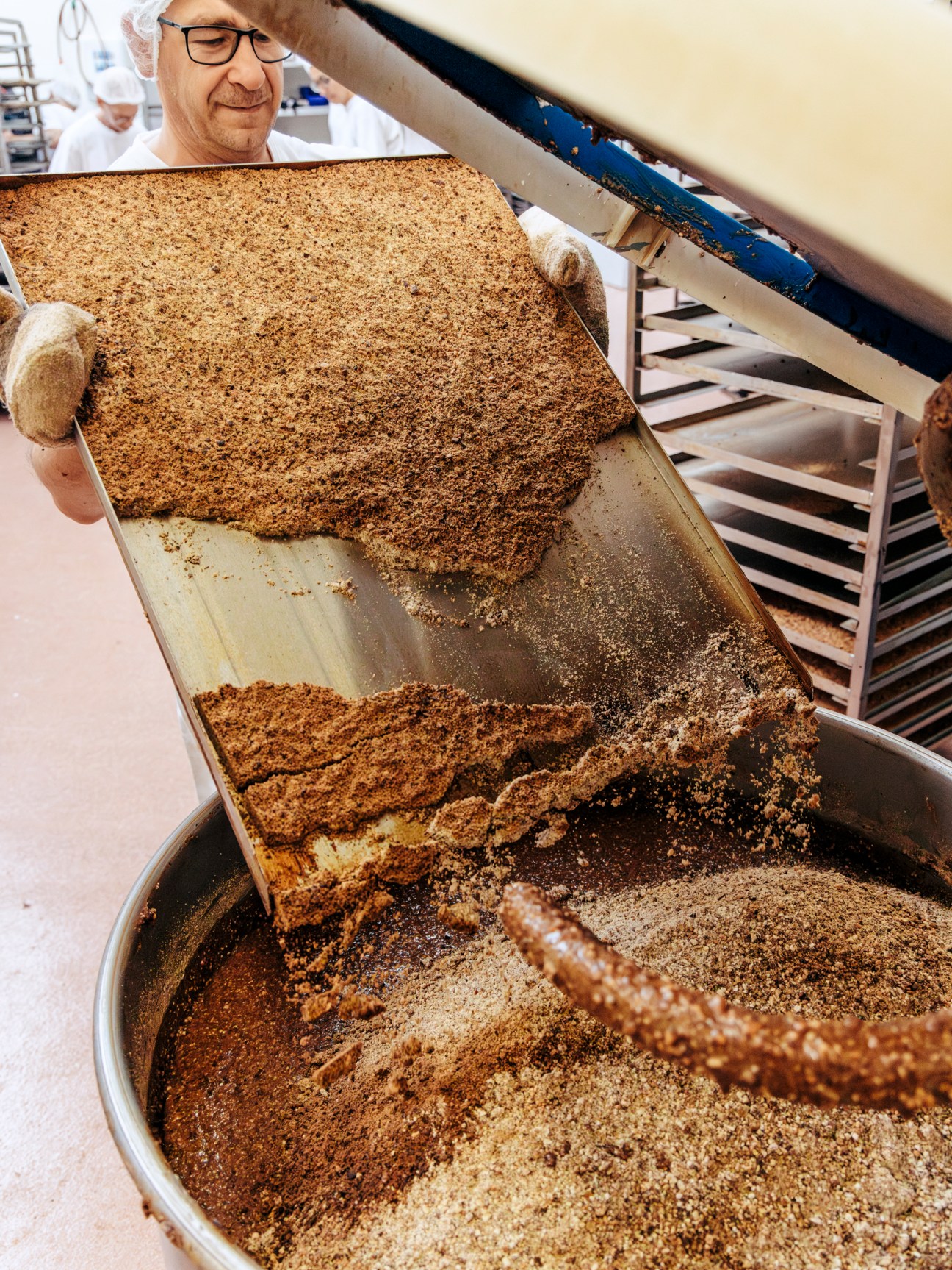 Baker holding large sheet of freshly baked Lebkuchen gingerbread at Lebküchnerei Woitinek in Nuremberg.