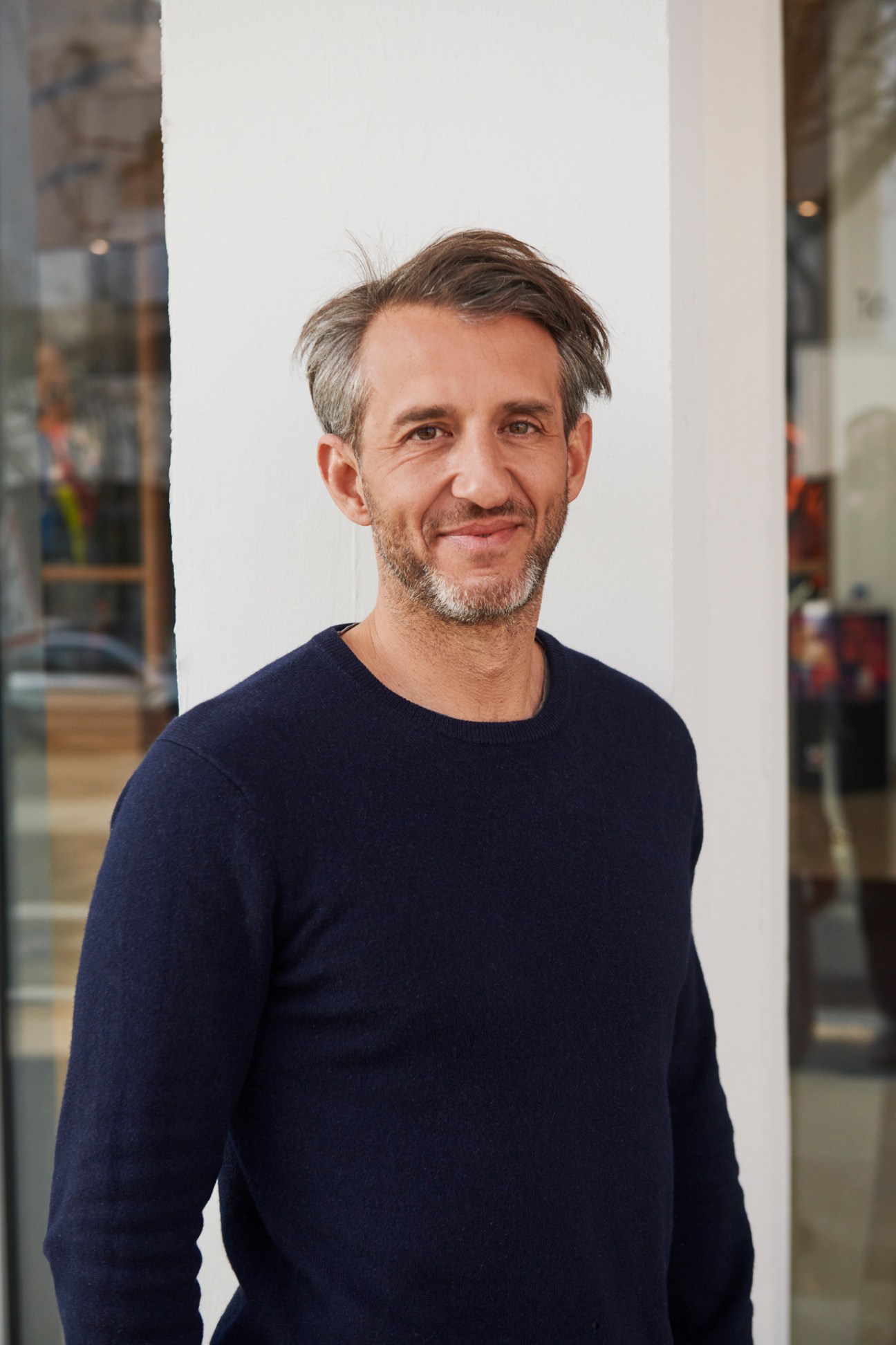 Romain Labbé, deputy director-general of Citynove, wearing a navy sweater in a modern office space