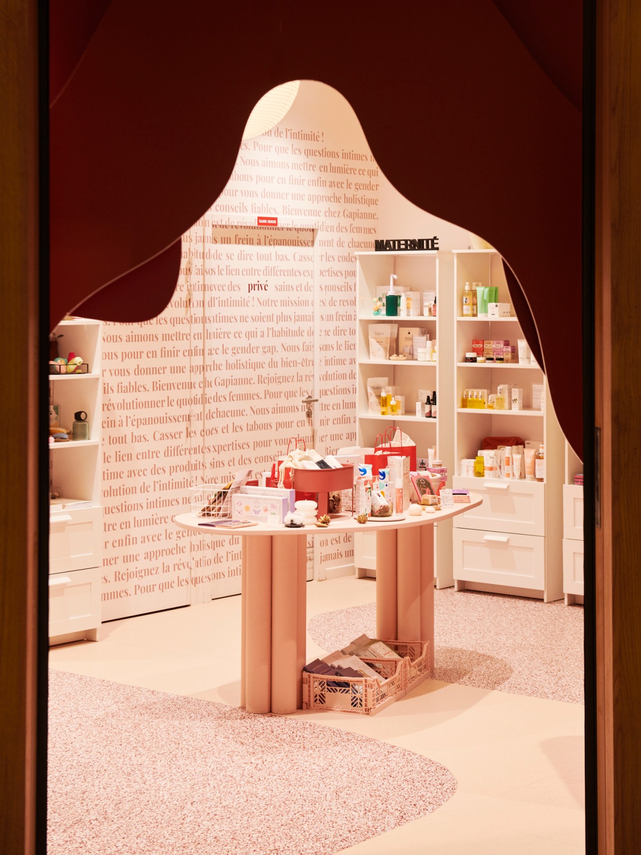 Modern retail interior with curved white shelving displaying beauty and wellness products
