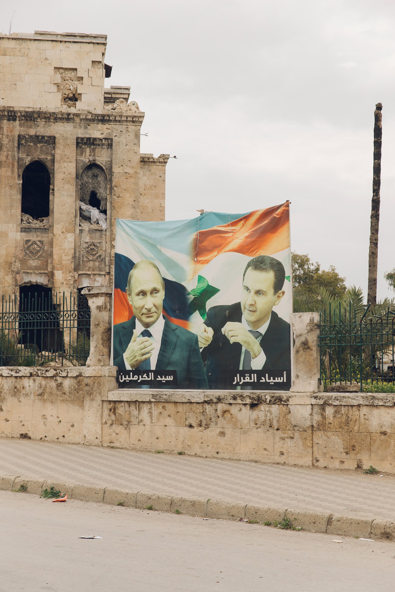 Propaganda posters in Aleppo showing Vladimir Putin on the left and Syrian President Bashar al-Assad on the right displayed on a street wall