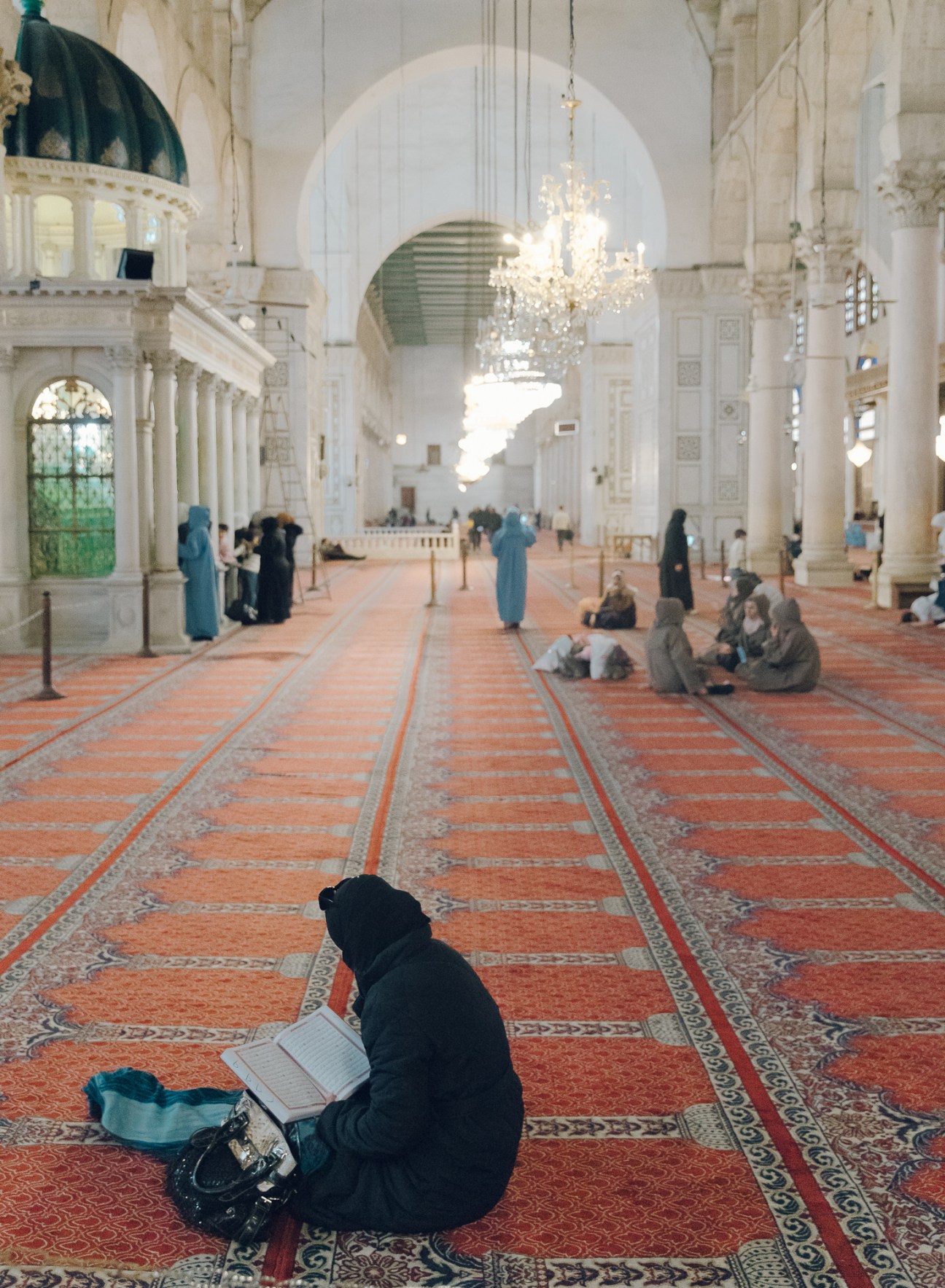 Worshippers gathered in the Umayyad Mosque during the final days of Ramadan, showing people seated on carpeted floors