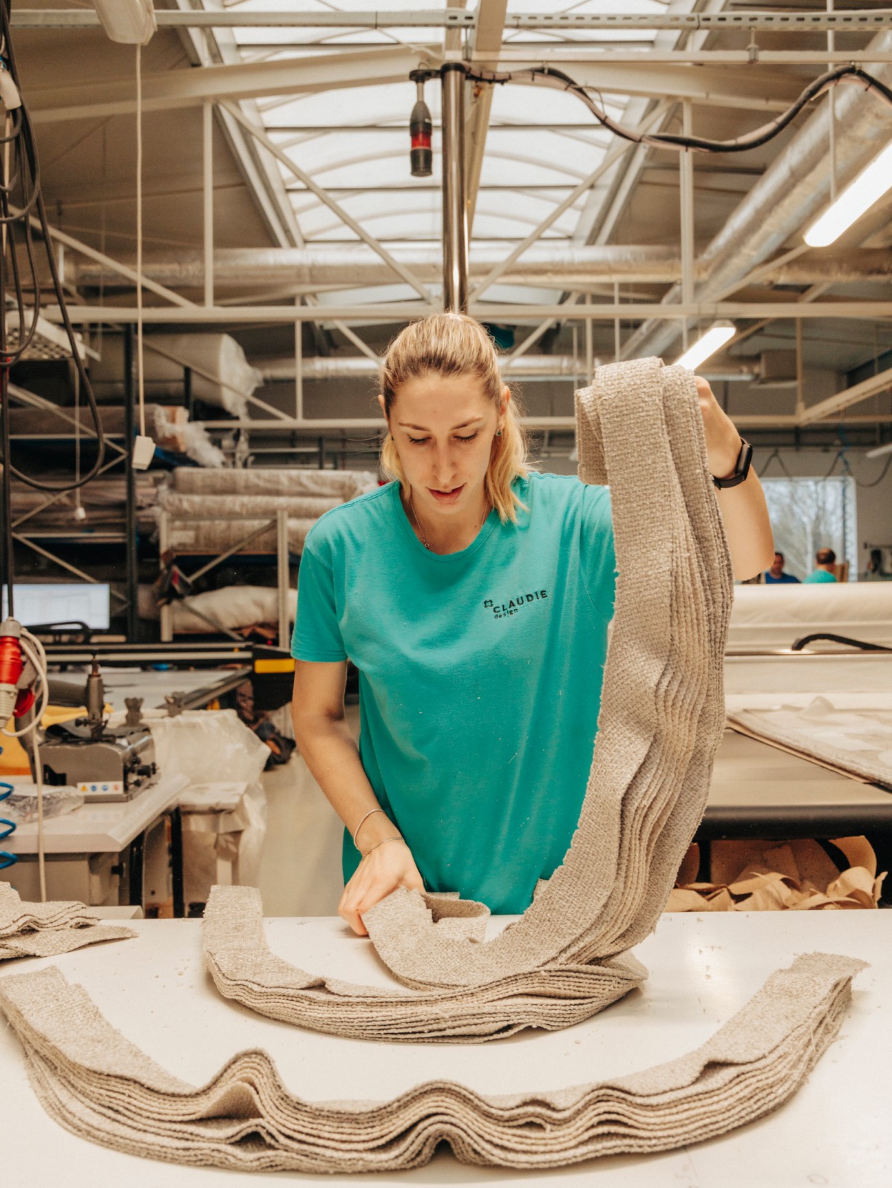 Worker sorting fabric materials at furniture factory