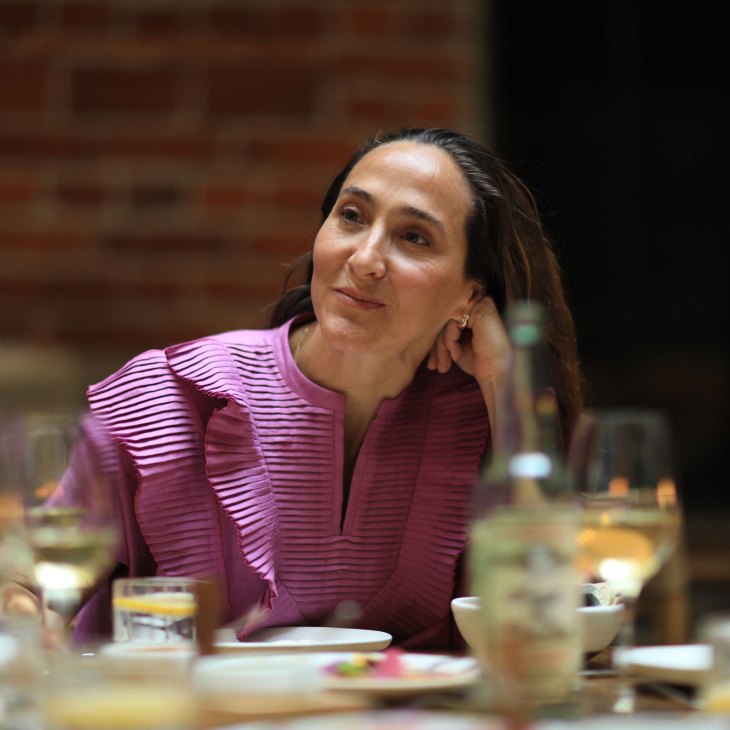 Gabriela Cámara seated at a dining table during a roundtable discussion about Mexico City's food scene.