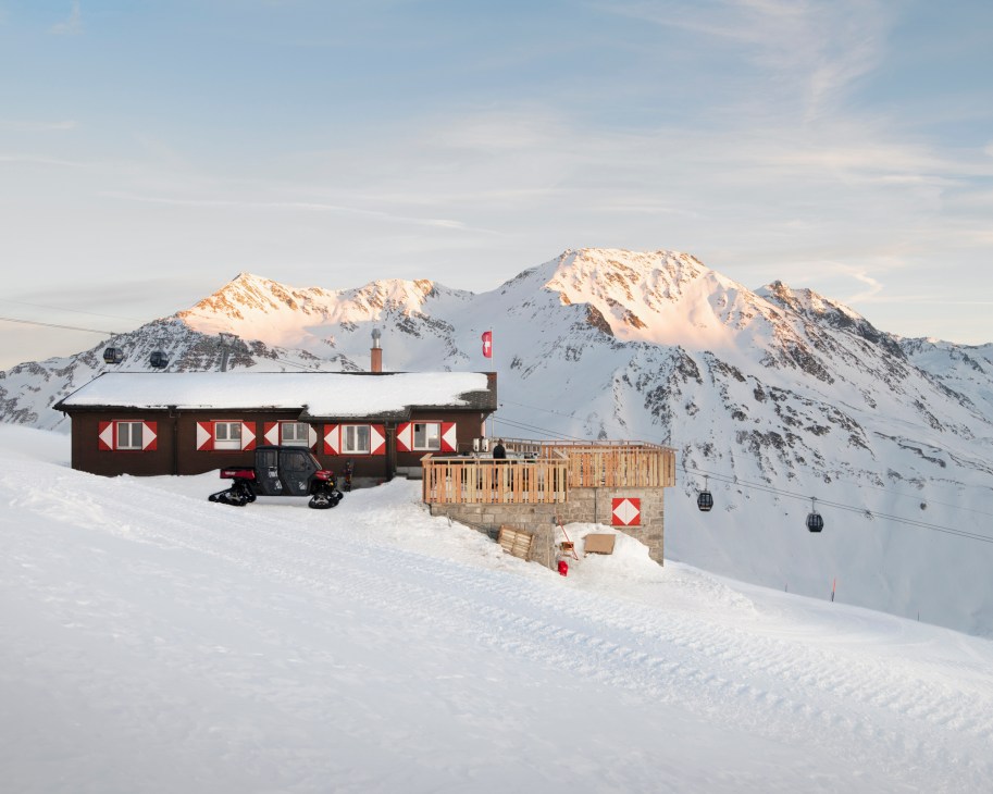 The Wachthuus restaurant exterior showing wooden alpine architecture with red and white painted shutters