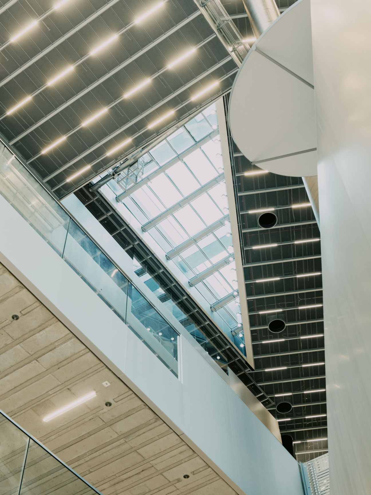Modern building interior showing connecting bridges across central atrium