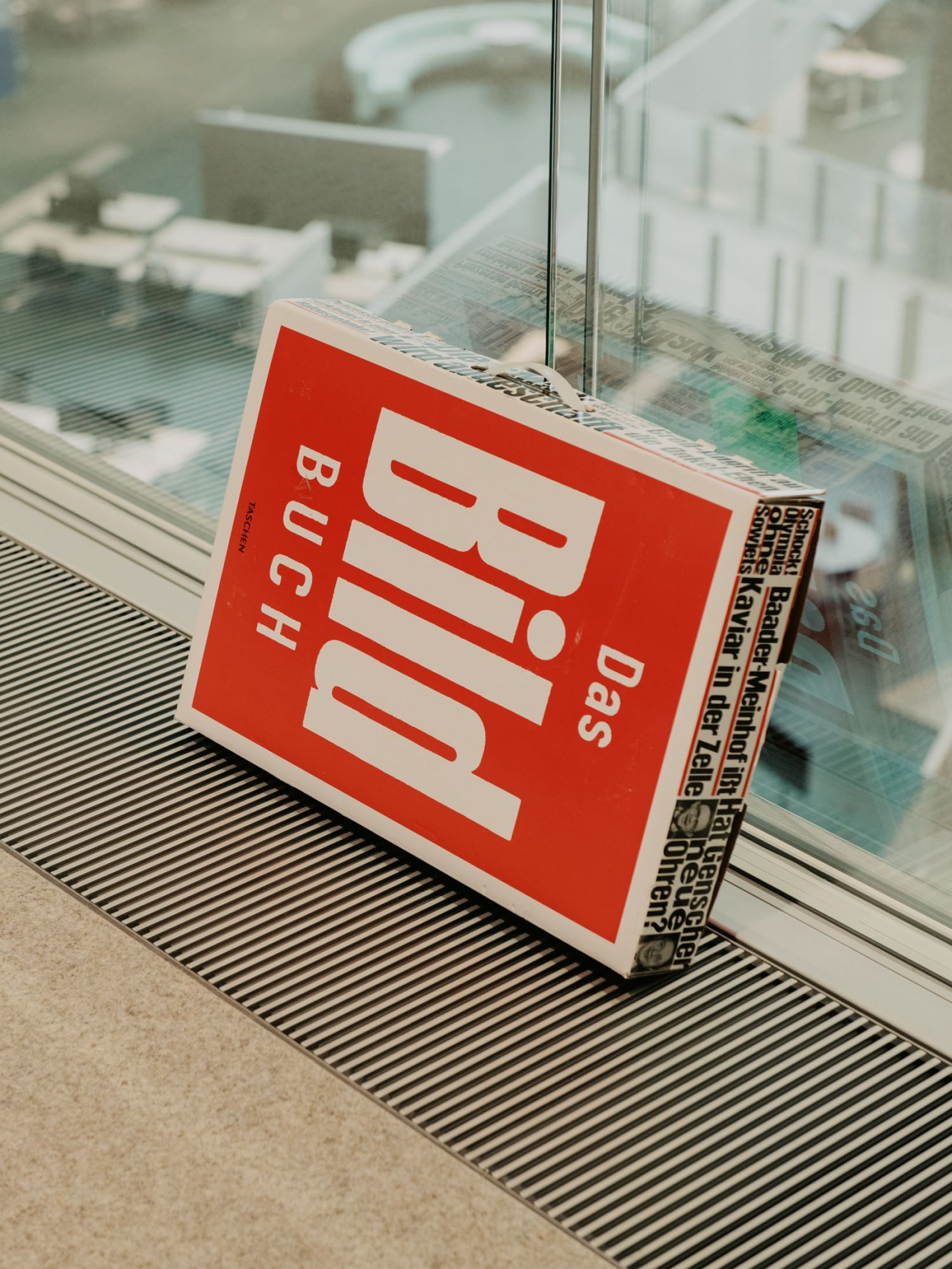 Person reading German Bild newspaper at modern workspace