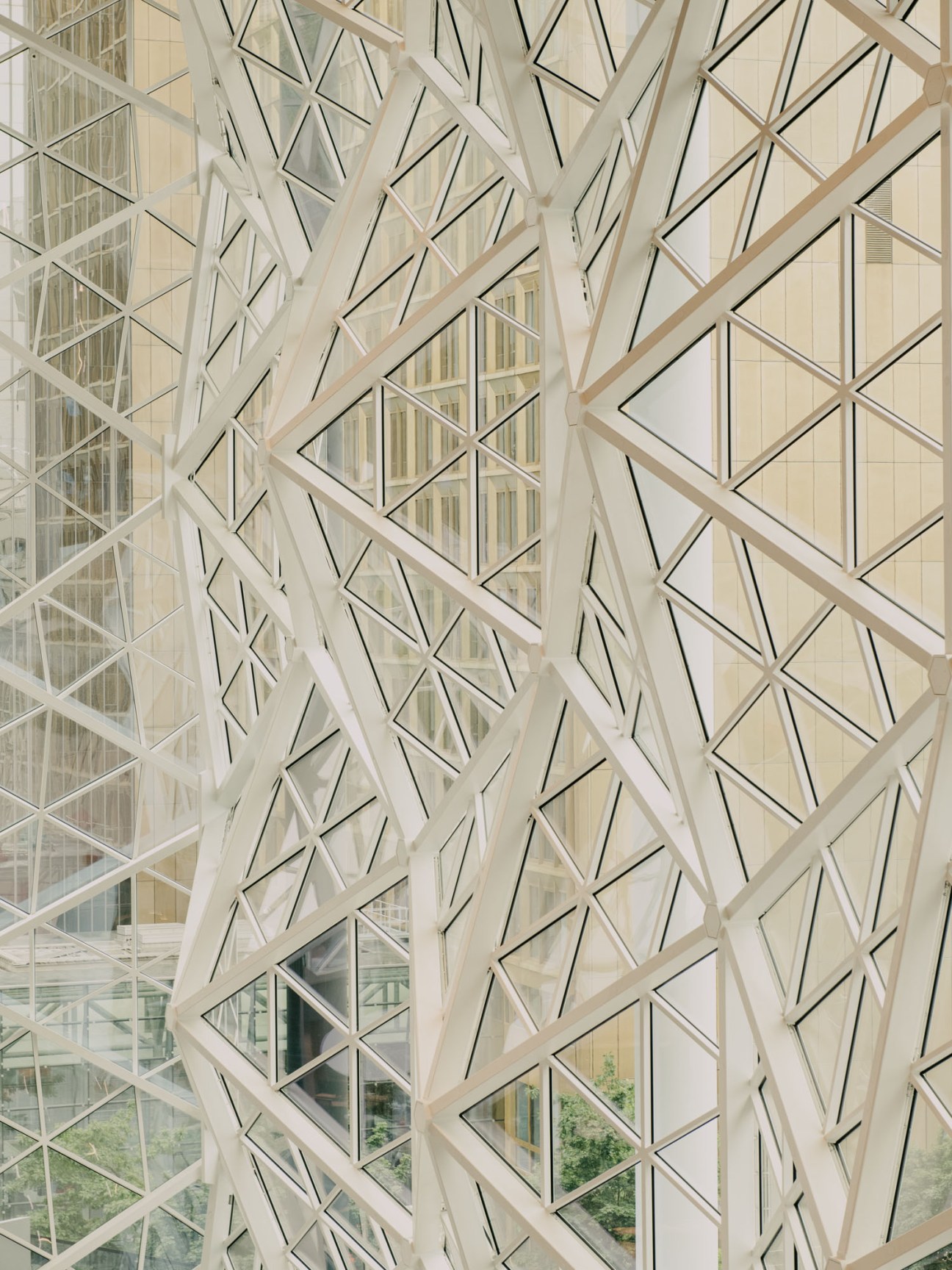 Geometric glass and steel architectural facade with diamond-pattern lattice framework