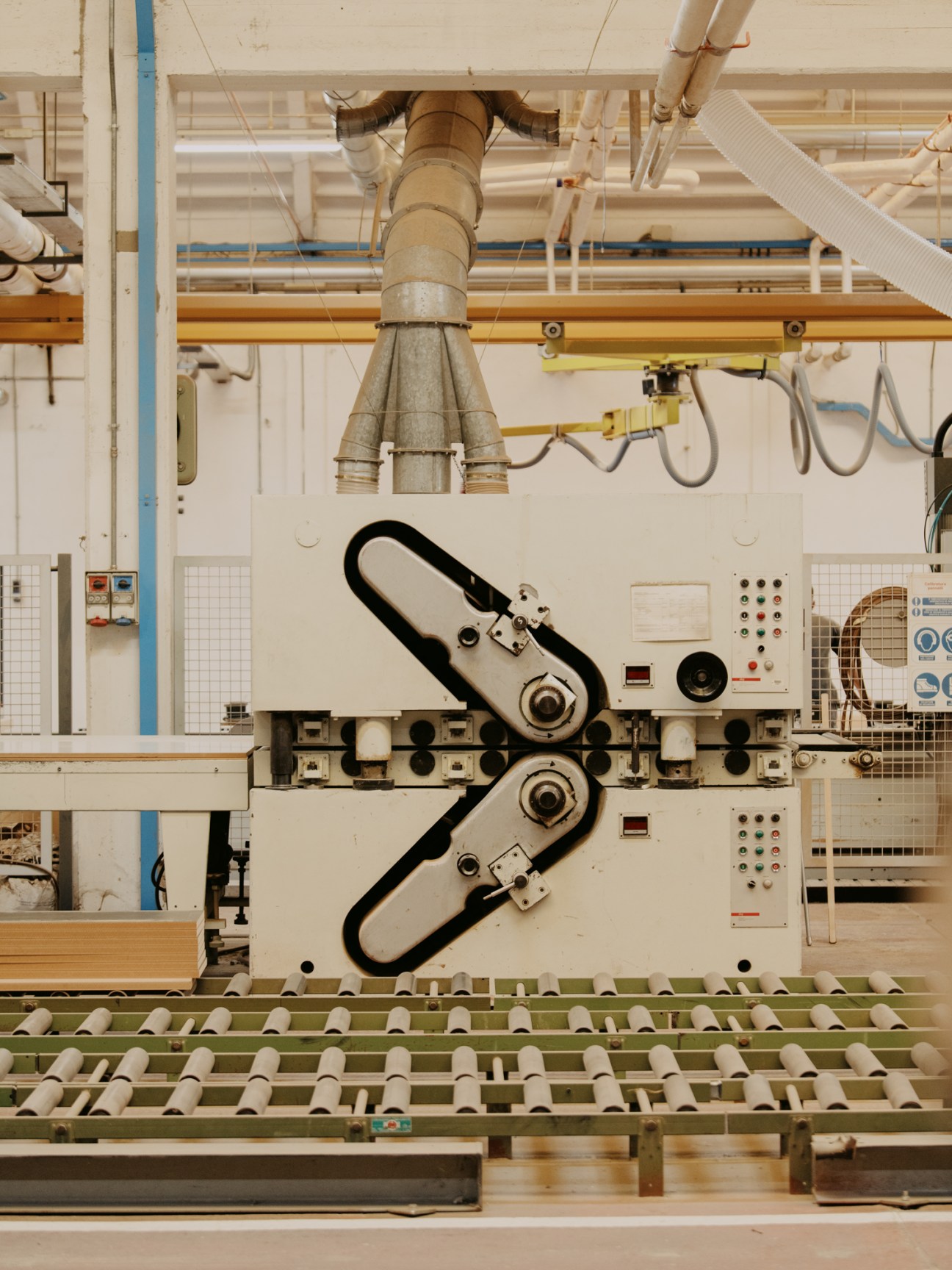 Factory worker operating wood-cutting machinery