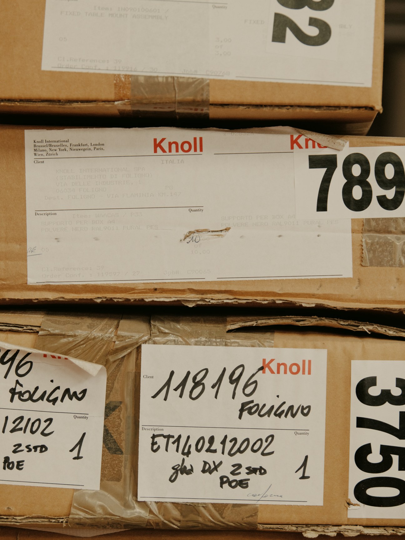 Cardboard boxes with Knoll shipping labels stacked and ready for delivery from the factory