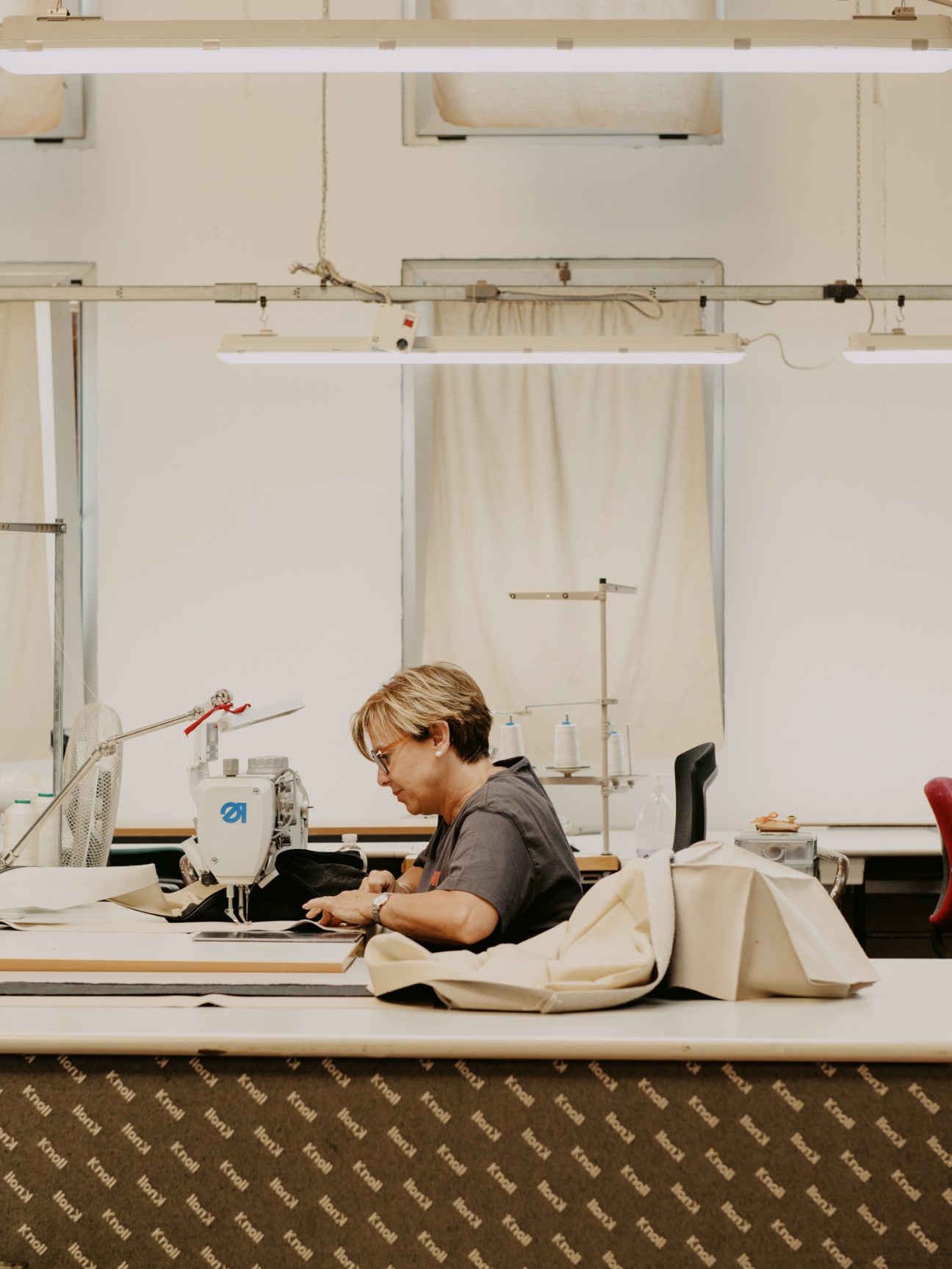 Luciana Contilli working at a sewing machine in the factory's textile department