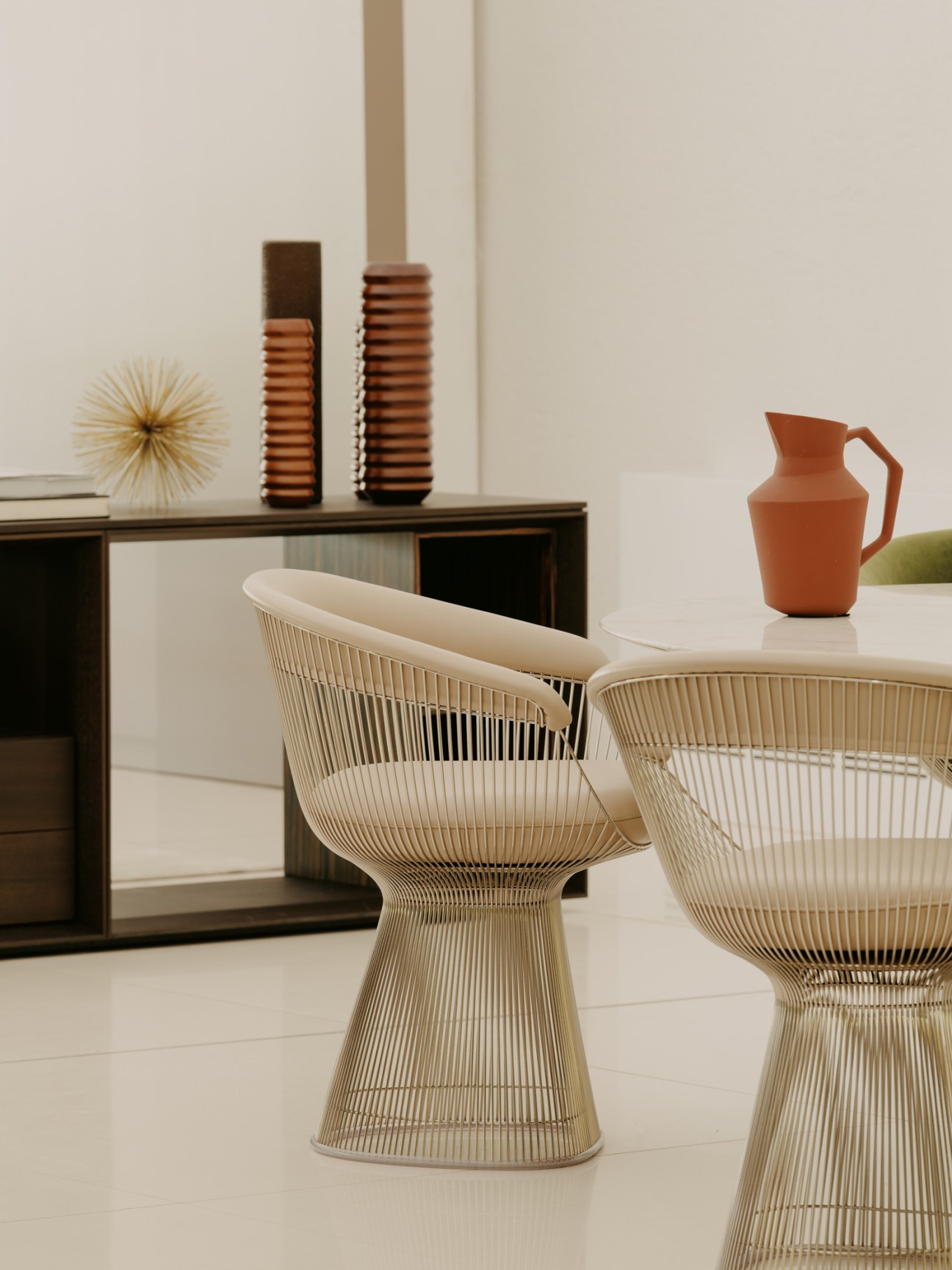 Platner chair and dining table with marble top by Warren Platner alongside a Matrioska credenza by Piero Lissoni