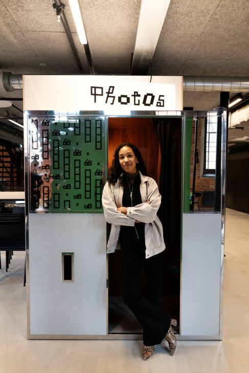 Production management student Isabel Garcia Toivanen stands in a photo booth installation at Berghs School of Communication.