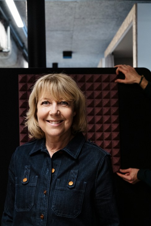 CEO Camilla Wallander smiles at the camera in a denim shirt inside Berghs School of Communication.