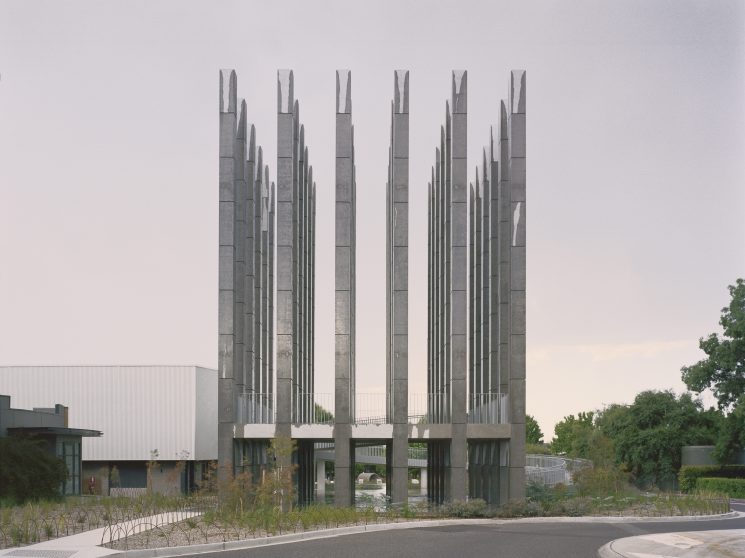 Tall concrete columns arranged in a grid formation surrounded by native plantings in Canberra's Dairy Road neighbourhood