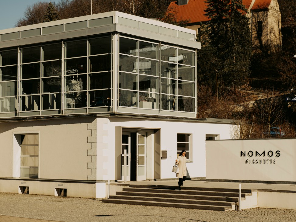 Nomos Glashütte building exterior with modernist glass architecture and company signage