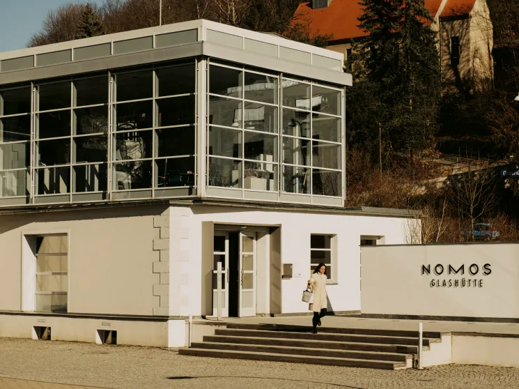 Nomos Glashütte building exterior with modernist glass architecture and company signage