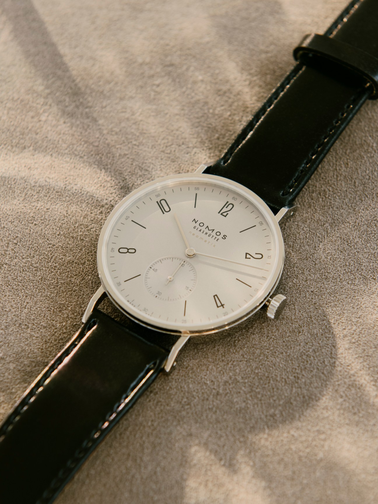 Detail of Nomos watch hands and dial markers showing precision manufacturing