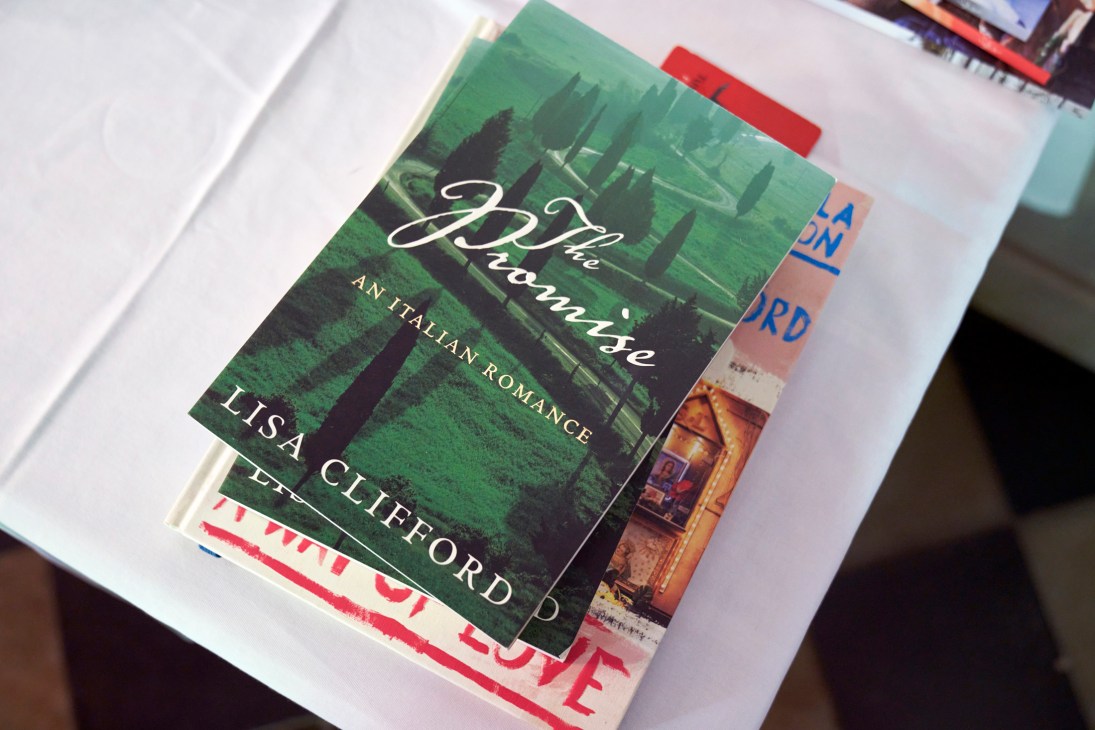 Book titled 'The Promise' by Lisa Clifford, described as 'An Italian Romance', placed on a white surface