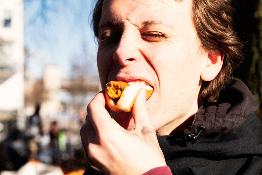 Team member enjoying a hot dog at the post-dive barbecue gathering