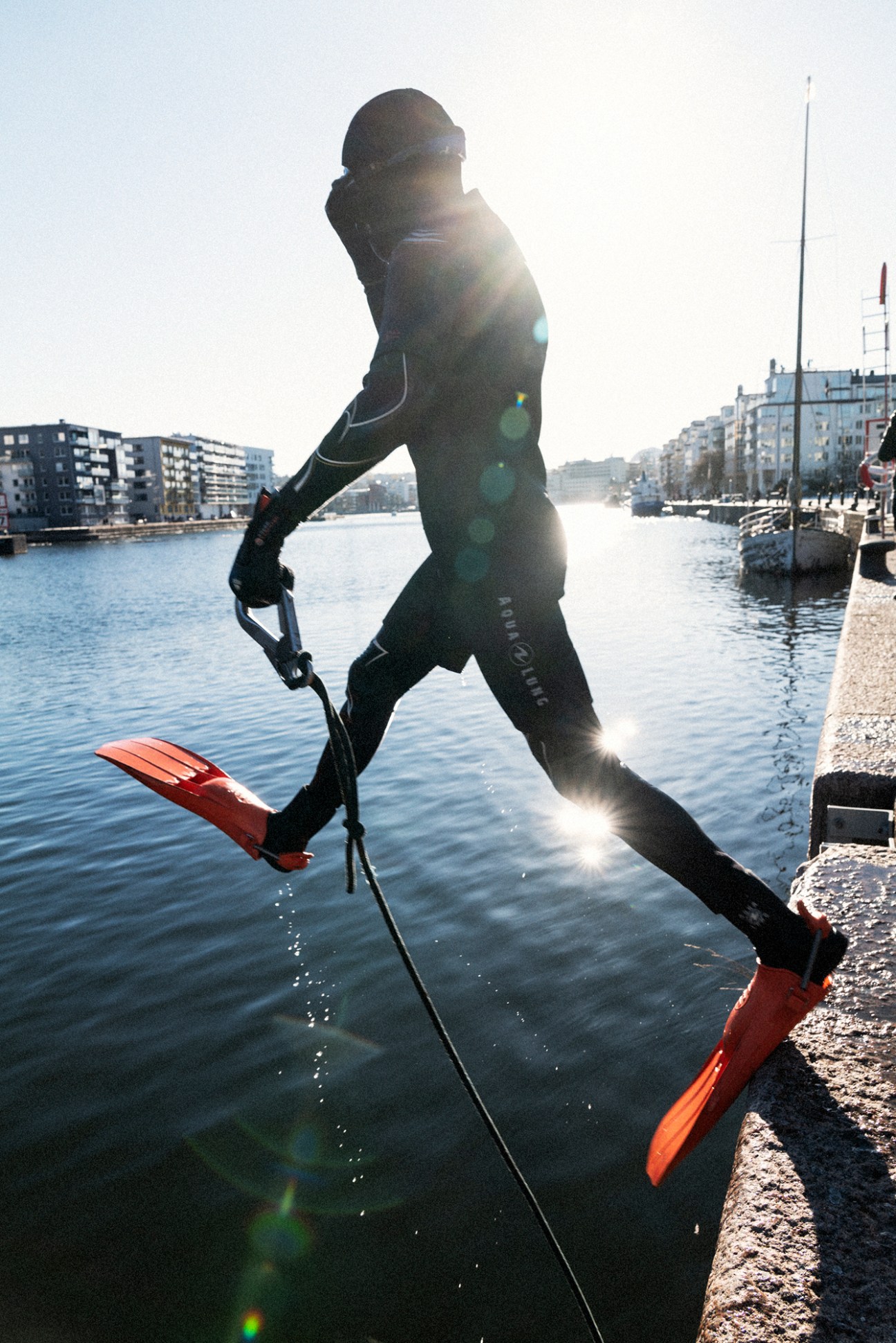 Writer in full diving gear entering the dark water of the canal during the cleanup operation
