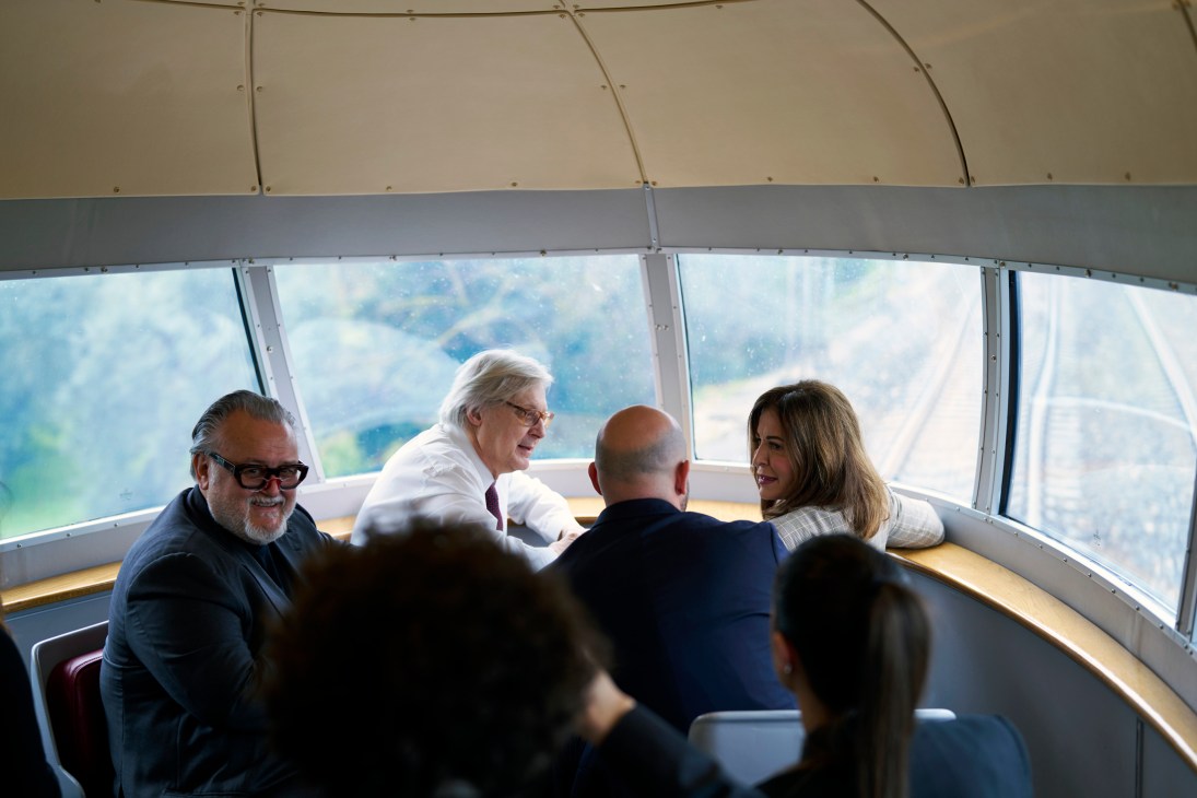 Deputy culture minister Vittorio Sgarbi and minister for tourism Daniela Santanchè seated by panoramic train windows