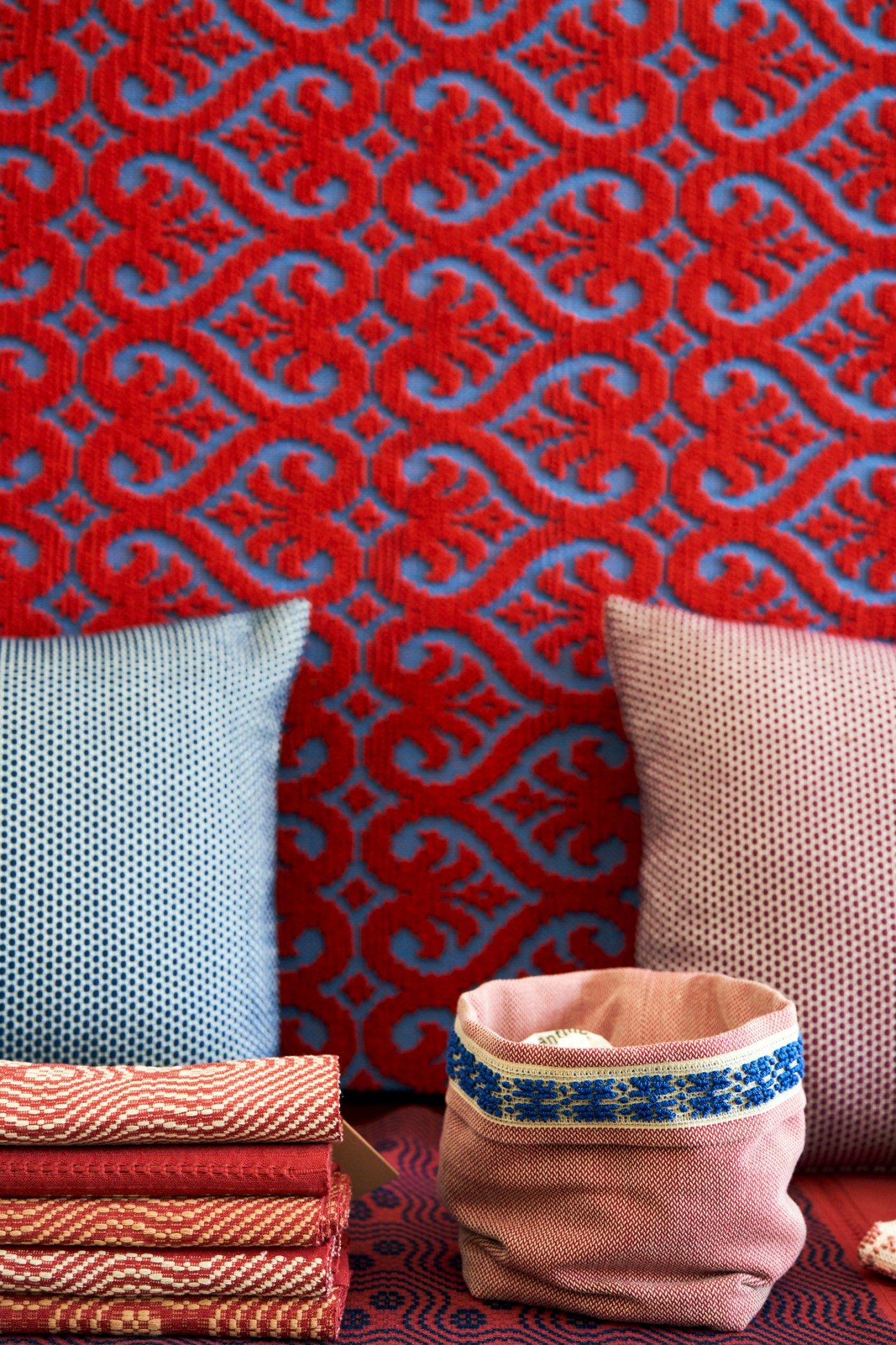 Colorful traditional fabrics and textiles with intricate patterns displayed at Le Costantine workshop