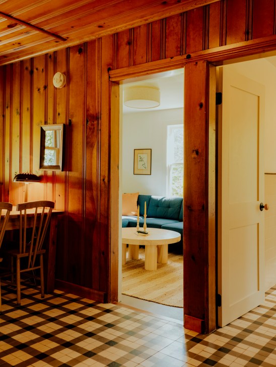 Bright hotel room interior with white walls and wooden beams
