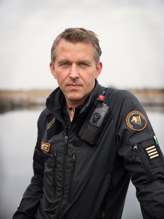 Portrait of a border guard officer in uniform standing outdoors