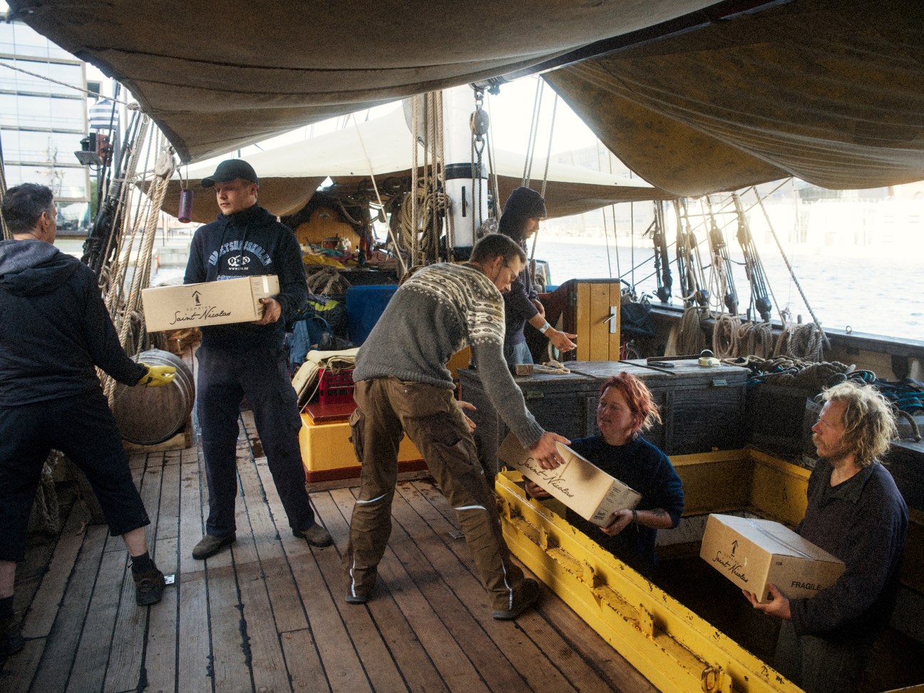 Captain Arthur Petrie (on right) and crew hoist cargo