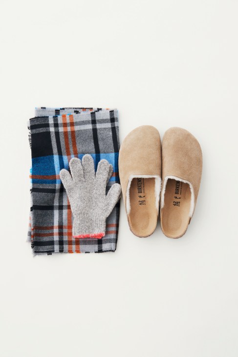 Birkenstock frogs, Sunspel scarf and Tembea gloves arranged on white background.