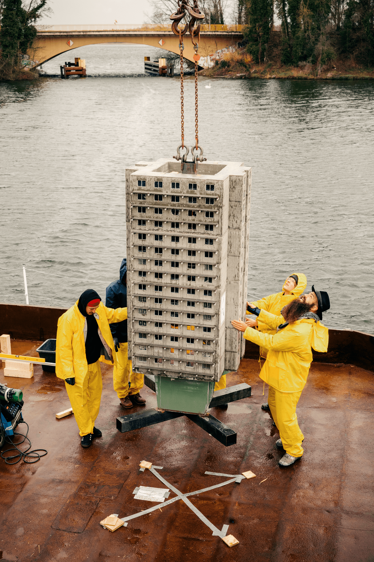 Miniature tower blocks and buildings being transported as cargo on a river barge