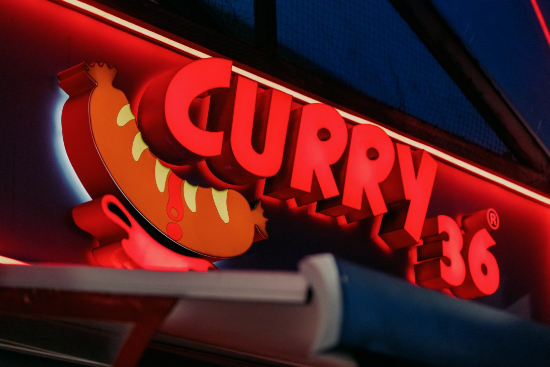 Exterior of Curry 36 restaurant with red illuminated signage at night