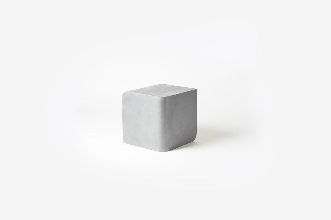Gray rounded cube-shaped furniture piece that functions as both seating and side table