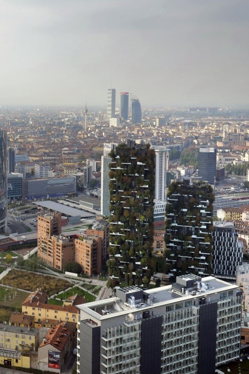 Aerial view of Milan cityscape showing modern green residential towers and urban development with Garibaldi district in background.
