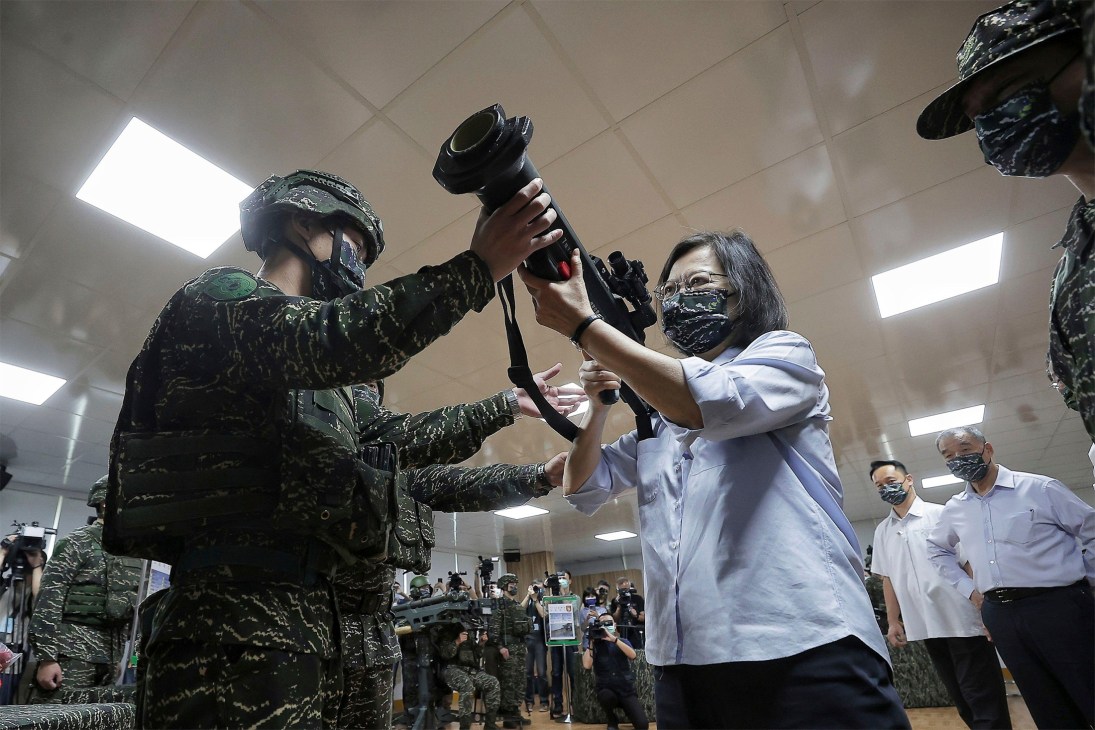 President Tsai Ing-wen holds a rifle during a military training demonstration.