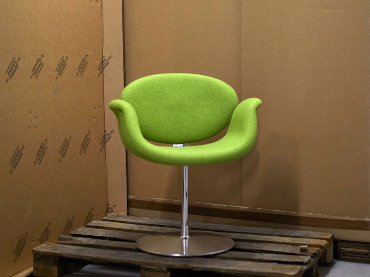 Pierre Paulin Tulip chair with bright green upholstery on wooden pallet in storage warehouse