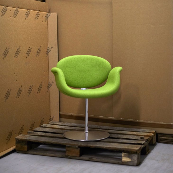 Pierre Paulin Tulip chair with bright green upholstery on wooden pallet in storage warehouse