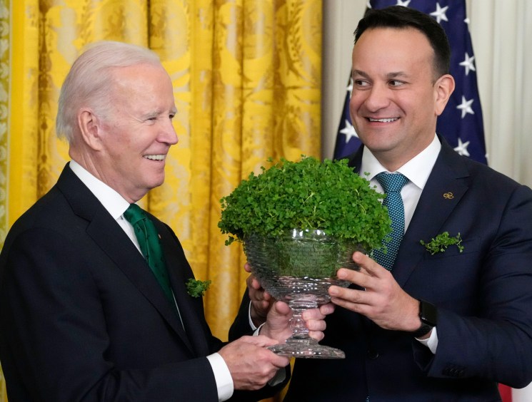 President Joe Biden and Ireland's Taoiseach Leo Varadkar hold a bowl of shamrocks during a St. Patrick's Day reception.