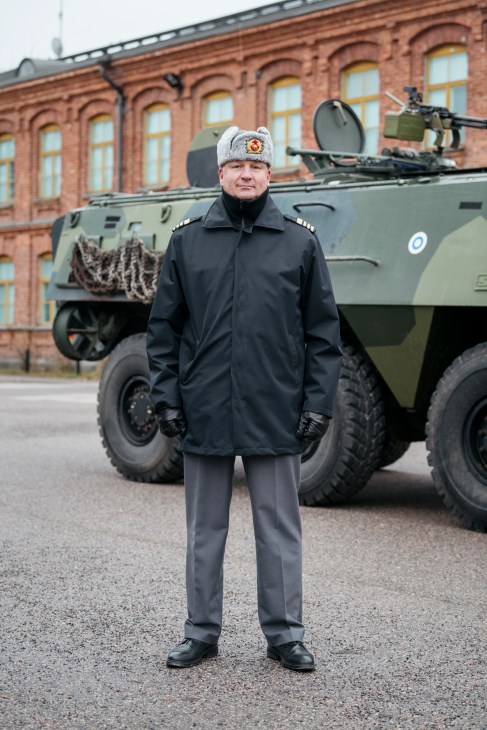 Colonel Sami Nurmi in military uniform standing in front of armored vehicle
