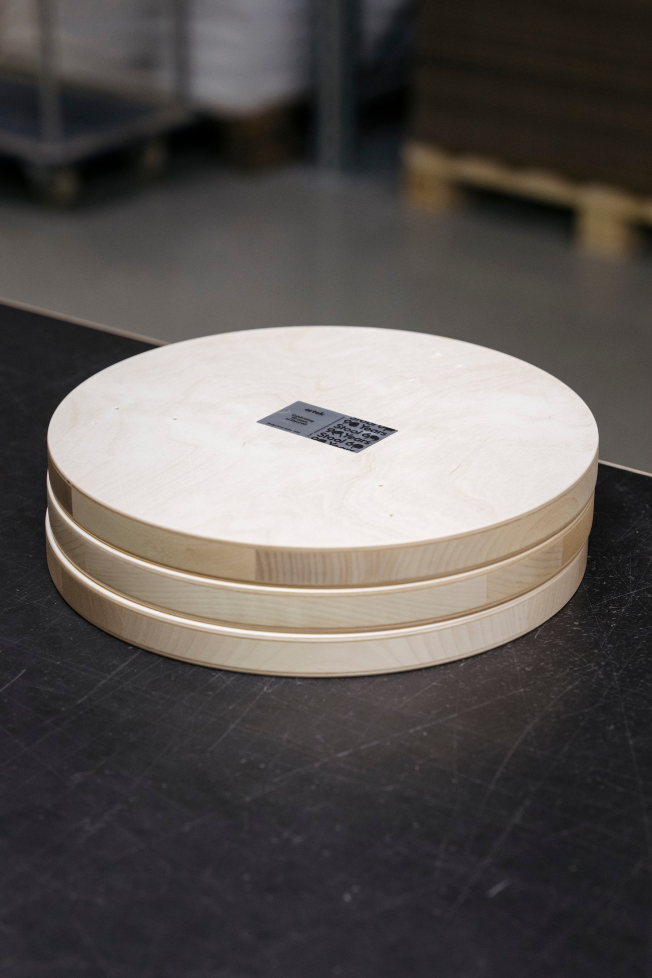 Close-up view of wooden Stool 60 seats showing the circular form and wood grain patterns