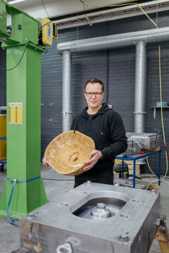 Portrait of Terja Koskenoja, CEO of Woodio, standing in their modern factory