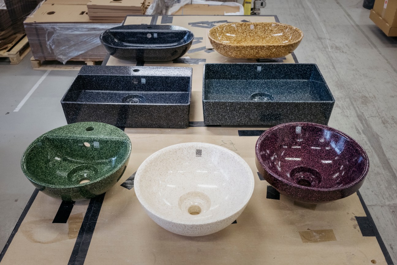 Various Woodio products in different colours showing the range of finishes possible with their wood composite material