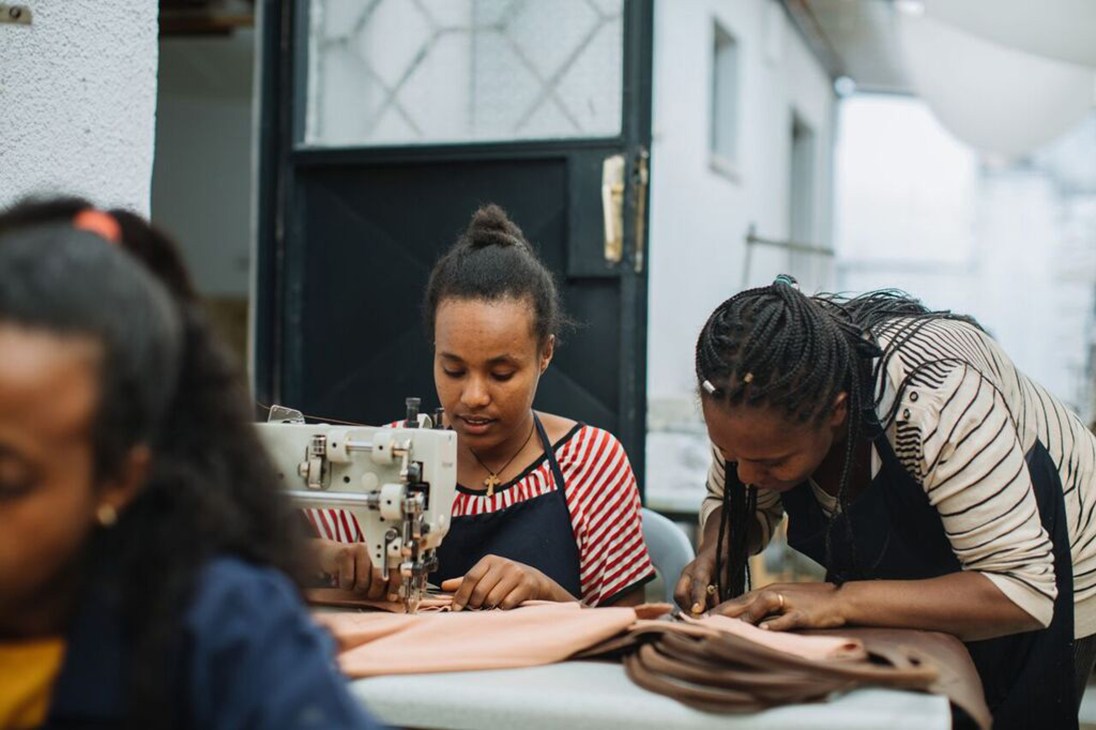 Women working at sewing machines in Sabegn's leather goods workshop in Addis Ababa, Ethiopia.