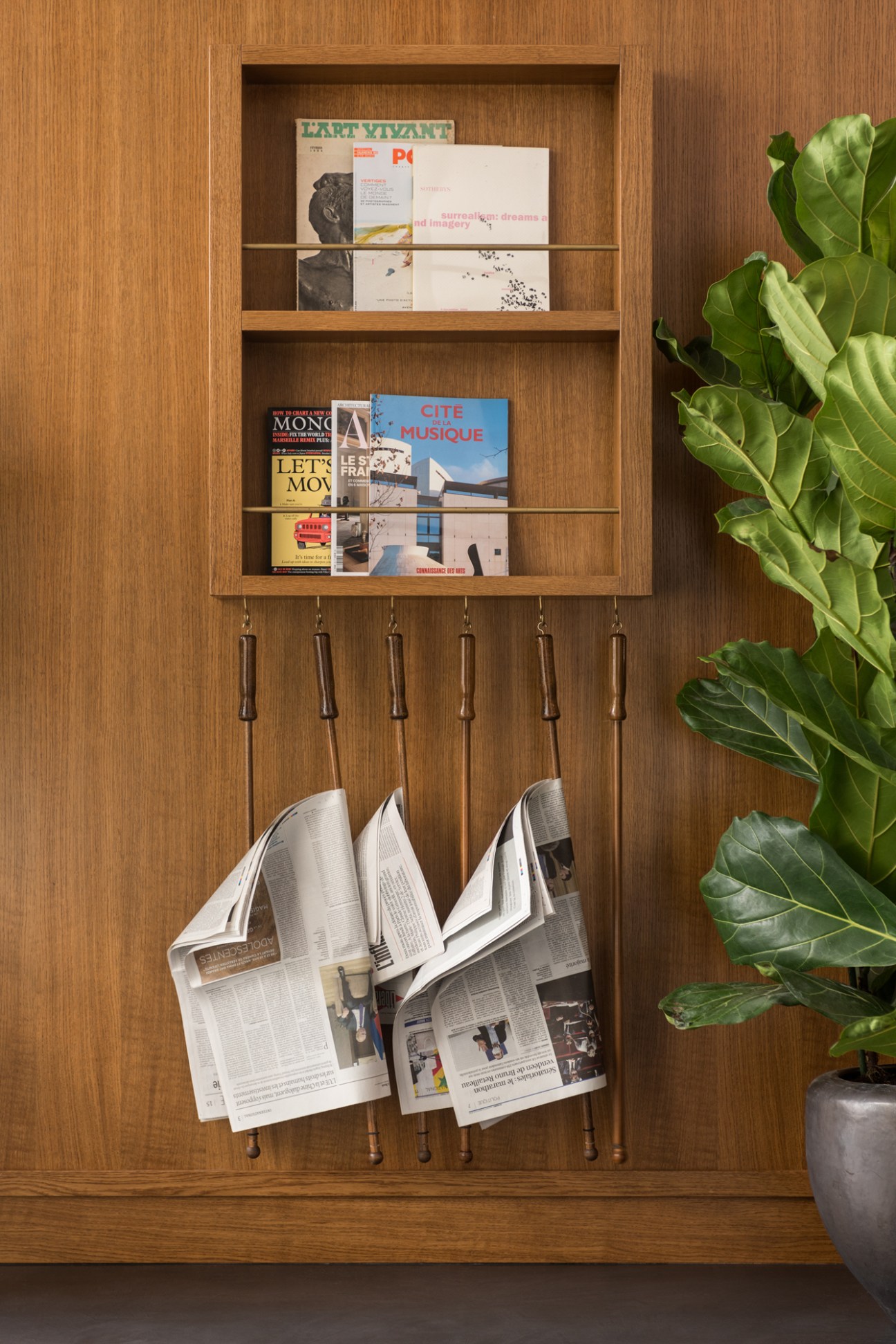 Interior of The Bureau co-working office in Paris showing wooden partition wall with built-in booths and bookshelves.