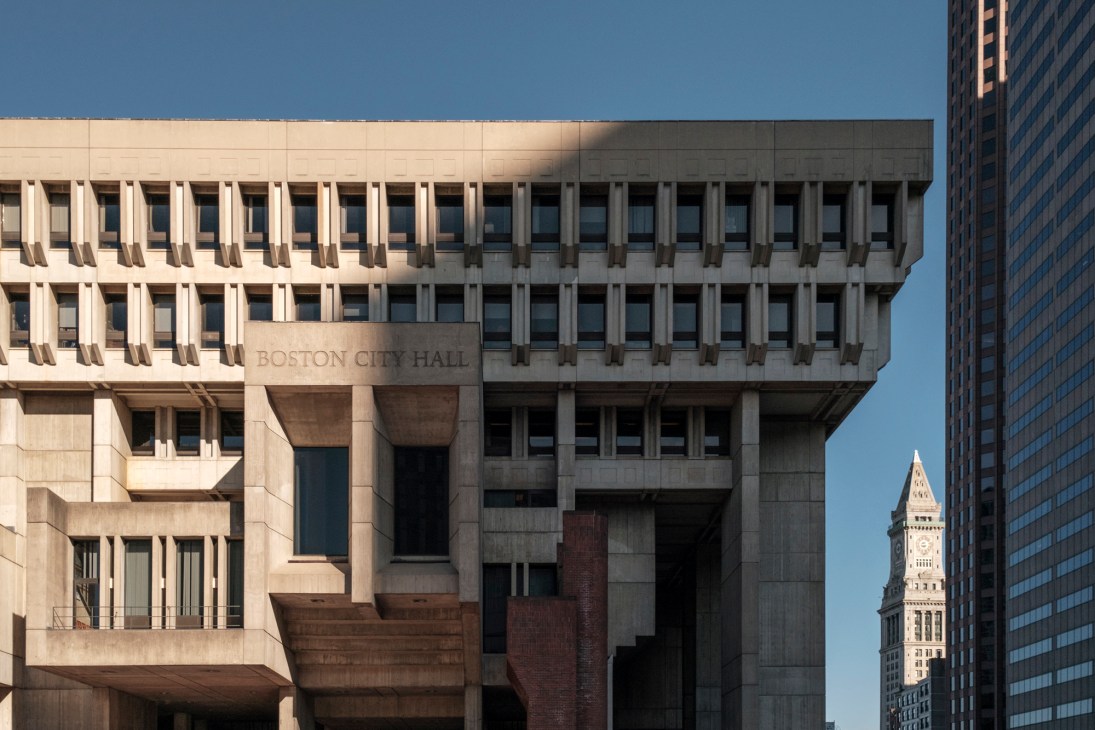 Boston City Hall's imposing brutalist concrete structure with geometric angular facade rising above City Hall Plaza