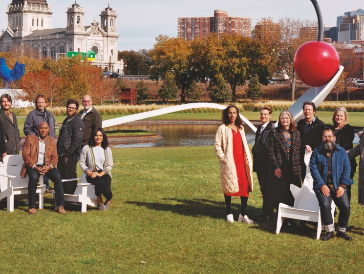 Walker Art Center team members pose outdoors in Minneapolis sculpture garden with Spoonbridge and Cherry artwork