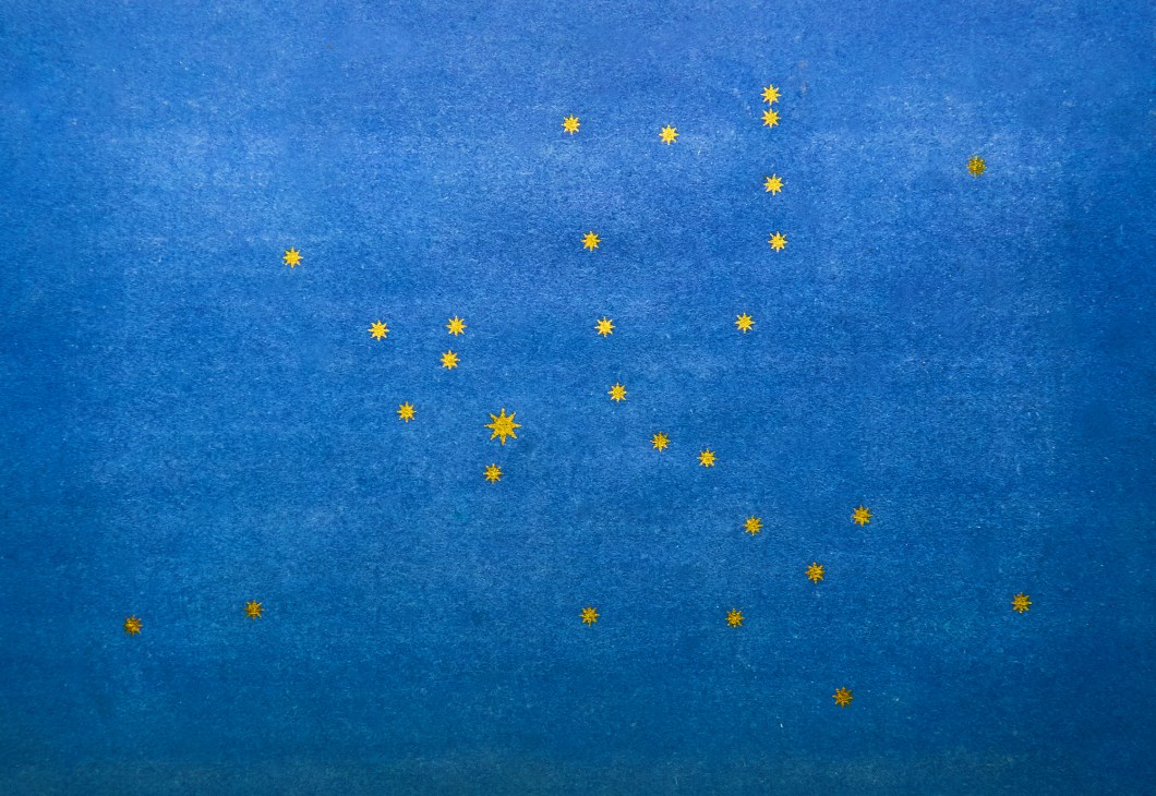 Blue flag with yellow stars scattered across it, designed by Salvador de Madariaga for the European flag