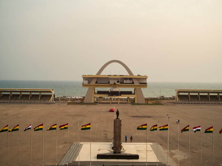 Black Star Square in Accra with Independence Arch, monument, and Ghanaian flags during golden hour