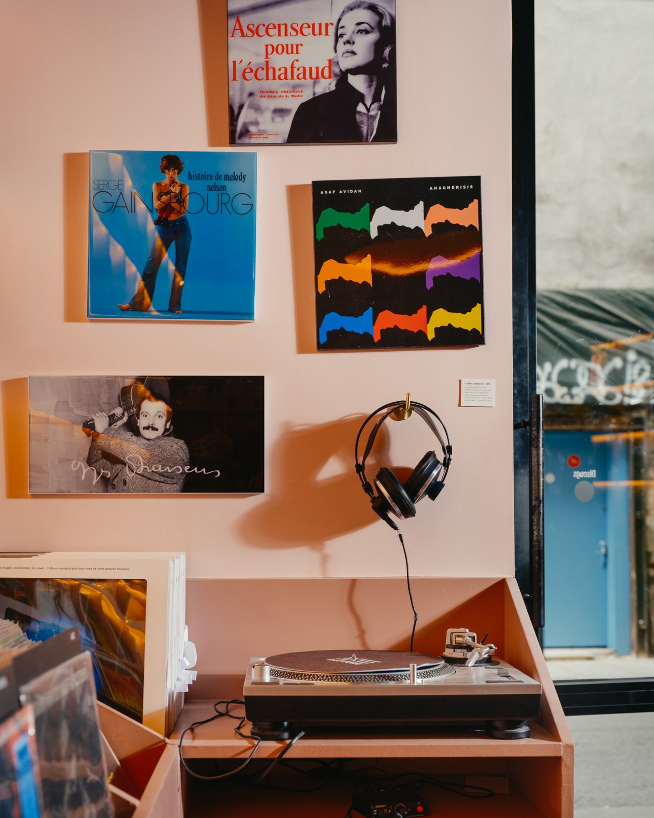 Interior of Rupture Records vinyl shop with pink parquet flooring and album covers displayed on walls