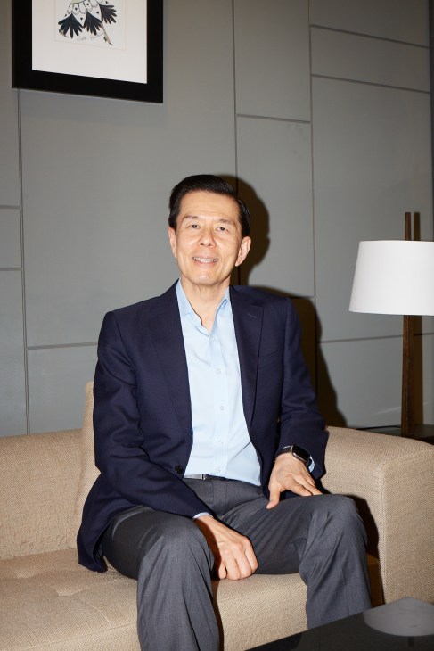 Yol Phokasub, CEO of Central Retail Corporation, sits on a beige sofa in a modern interior.